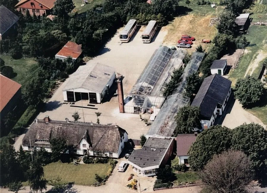 Historische Luftaufnahme von Blumenladen und Busunternehmen am Storchennest
